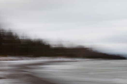 Intentional camera motion photo of trees on a beach. Near Southampton, Ontario, Canada