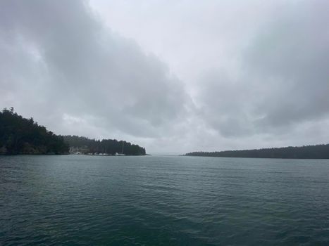 Grey skies over mountains and ocean near Montague Harbour, Gulf Islands, Canada