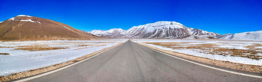 The panoramic road that crosses the plateau of Castelluccio di Norcia in Umbria Italy in the winter season 