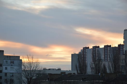 New buildings against the backdrop of a pink clouds in the city