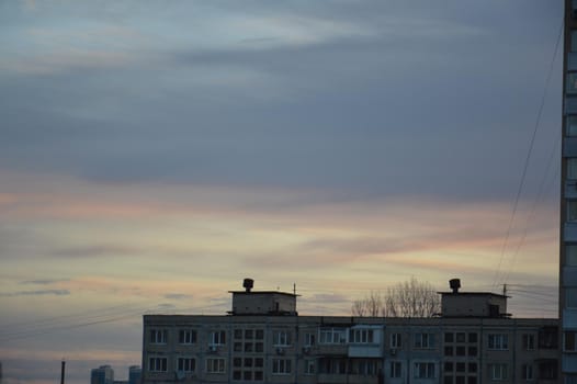 New buildings against the backdrop of a pink clouds in the city