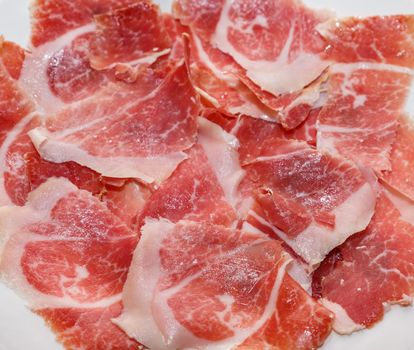 Top view of serrano ham slices, closeup view
