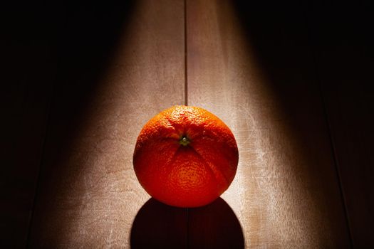 Orange fruit on the wooden table. Dark Food Photography.