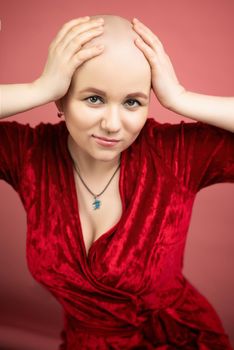 the portrait of a bald woman with cancer after chemotherapy smiling at the camera