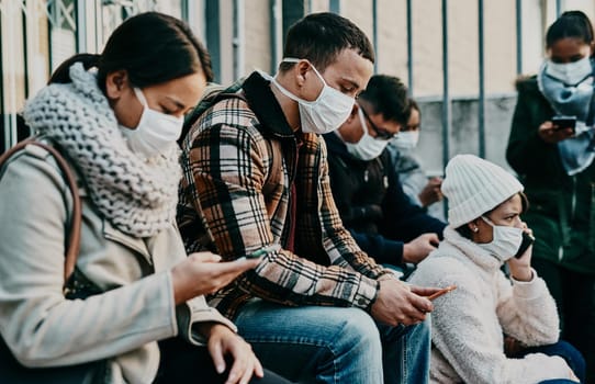 Shot of a young woman using a smartphone and wearing a mask while travelling in a foreign city