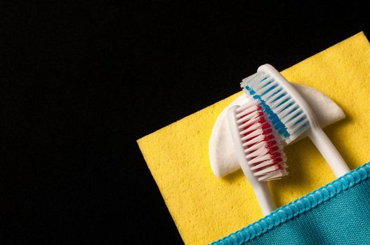 Toothbrushes under a blanket, on a black background