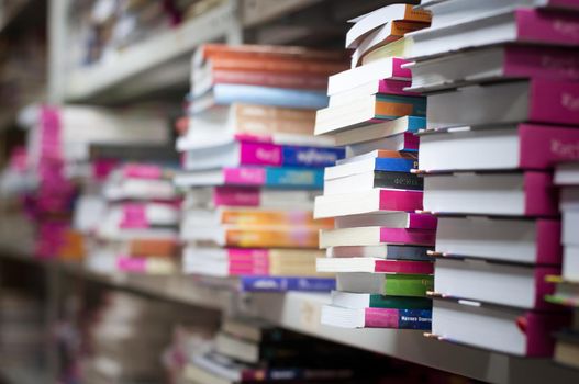 piles of books on the shelves of the archive