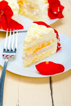 whipped cream mango cake with red rose petals 