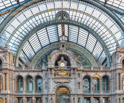 Famous old clock on the facade of the old beautiful railway station in Antwerp