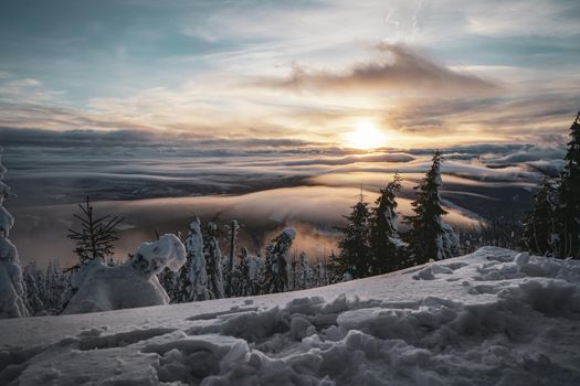 Snowy Peak of Mountain in Europe with sunset and Low Clouds Inversion. High quality photo