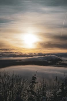 View from Mountain Peak with sunset and Low Clouds. High quality photo
