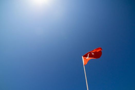 The waving flag of Turkey. Against the blue sky.