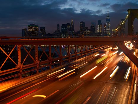 Long exposure shot of cars leaving Manhattan via Brooklyn Bridge in New York, USA