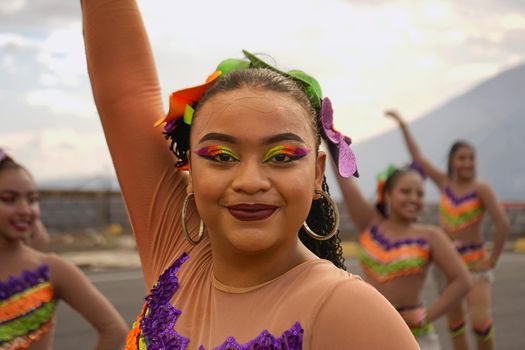 Portrait of a Latina Teenager from Nicaragua dressed and dancing in comparsa clothing at a traditional event in the country.
