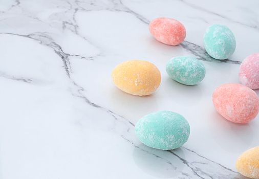 Layout of multi-colored Easter eggs, on a marble table. Soft focus. Close-up. copy space