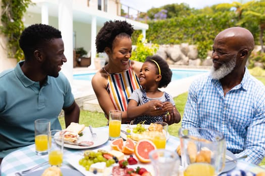 African american family spending leisure time together at backyard during brunch. family, love and togetherness concept, unaltered.