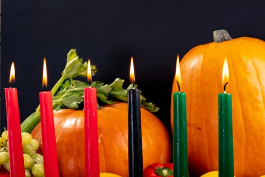 Composition of halloween decoration with candles and pumpkins on black background. horror, fright, halloween tradition and celebration concept digitally generated image.