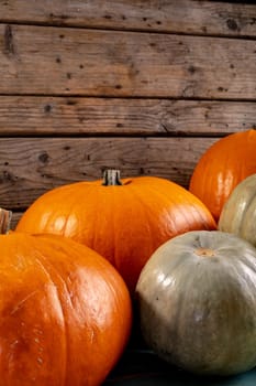 Composition of halloween decoration with pumpkins on wooden background. horror, fright, halloween tradition and celebration concept digitally generated image.