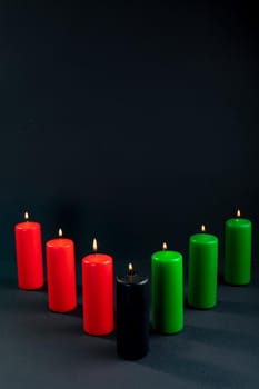 Composition of halloween candles and copy space on black background. horror, fright, halloween tradition and celebration concept digitally generated image.