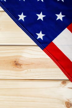 Overhead view of usa flag with stars and stripes on wooden table. patriotism, symbol and identity.