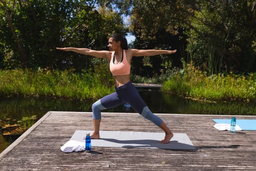 Full length of young woman in sportswear practicing yoga in park. healthy lifestyle and body care.