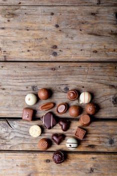 Directly above shot of chocolates arranged in heart shape with copy space on table. valentine's day, sweet food and love concept.