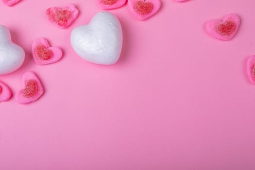 Overhead view of heart shaped sweet food on pink background, copy space. valentine's day, food and love concept