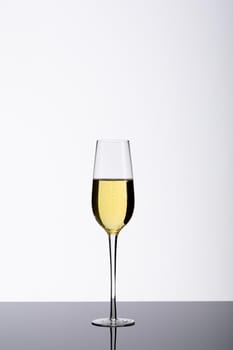 Champagne flute on table isolated over white background, copy space. drink, celebration and studio shot.