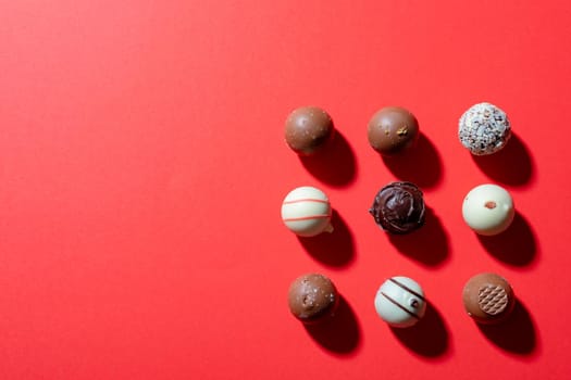 Directly above shot of dessert arranged on red background, copy space. valentine's day, food and love concept.