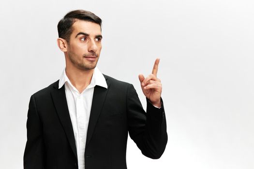 business man showing index finger up in black business suit work successful trader isolated. Copy space. High quality photo