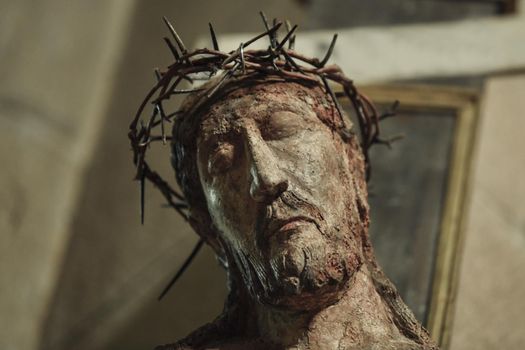 A statue of Jesus hanging on a cross in a church