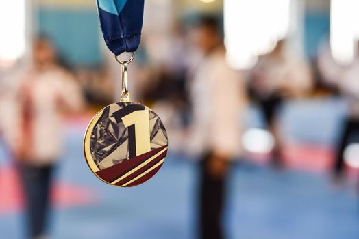 gold medal on a blurred background with copy space. medal for first place in a competition.