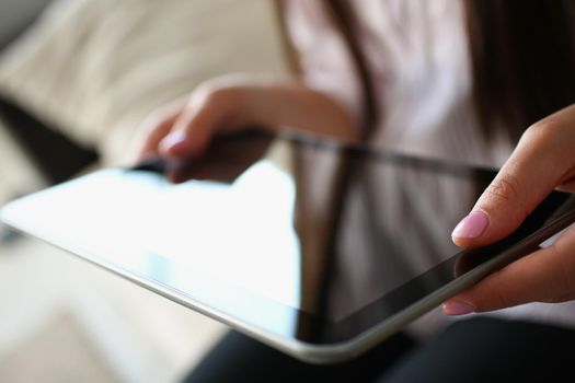 Close-up of female using digital tablet device for work or entertainment, black gadget screen, turn off. Modern technology for people usage. Mockup concept