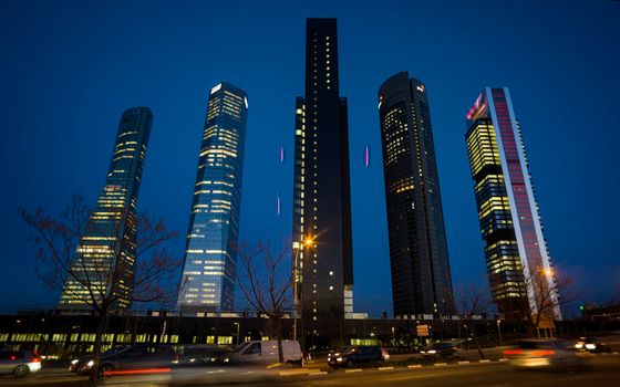 Night view of the Cuatro Torres Business Area, Madrid's main financial area. The glass tower is the tallest in Spain, at 249 meters.