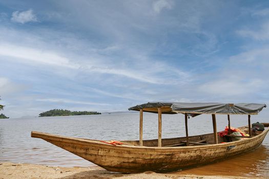 wooden boat at the shore of eastern african lake