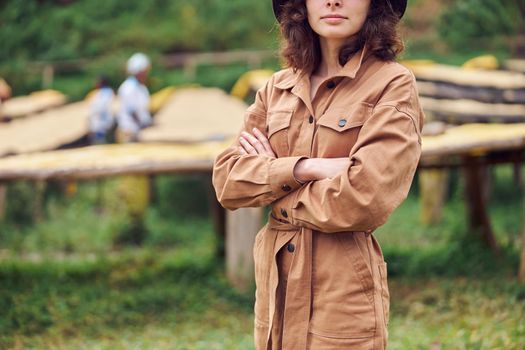 caucasian woman is standing in front of coffee washing station in eastern africa region