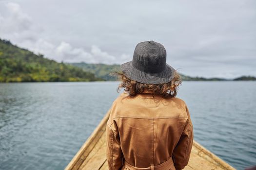 woman from behind is travelling in touristic places of mountain region of easter African lakes