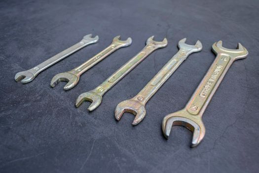 Set of new wrenches made of chromium and vanadium alloy on a dark surface