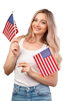 Portrait of a young smiling woman holding USA flag isolated on white background