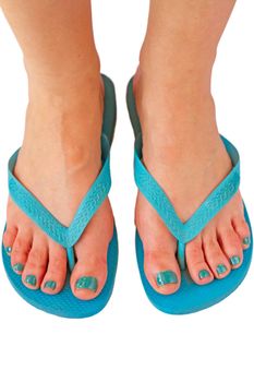 Top view of woman feet with thong and painted fingernails for summer