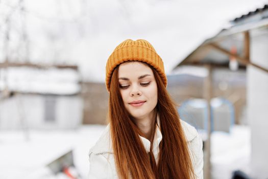 red-haired woman in a hat in winter outdoors. High quality photo