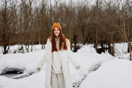 woman red hair walk in the fresh winter air There is a lot of snow around. High quality photo
