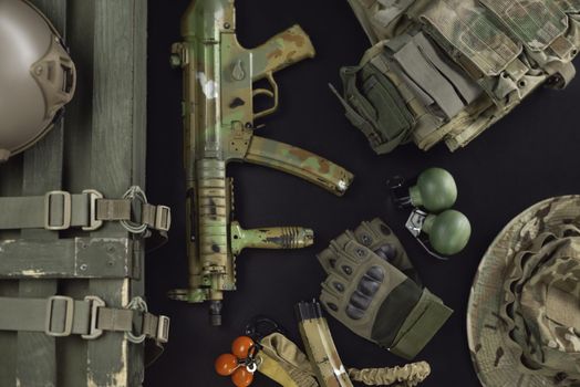the military ammunition top view of a grenade box, rifle, grenades, bulletproof vest, helmet and other tactical items
