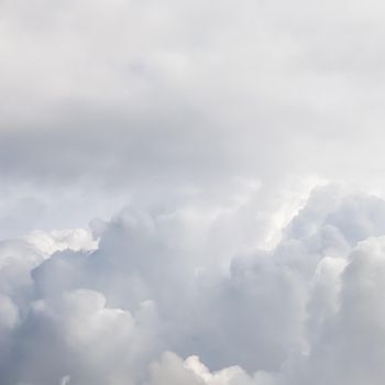 Cloudy sky background with sunlight shining through white clouds. Natural backdrop