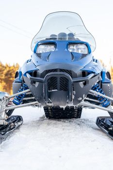 Snowmobile in winter conditions. Snowmobiling in winter in the north. Extreme kind of winter outdoor sport.