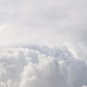 Cloudy sky background with sunlight shining through white clouds. Natural backdrop