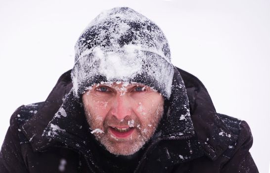 Portrait and photography of people from the side. Portrait of a tourist during a storm and snowfall.