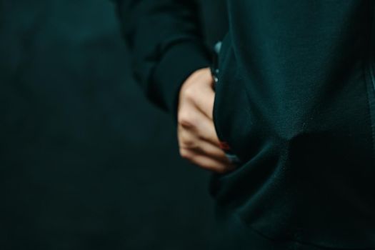 Guy is threatening with pistol in his jacket pocket. Thief hides weapon in clothes. Night criminal and robber. Close up with copy space.