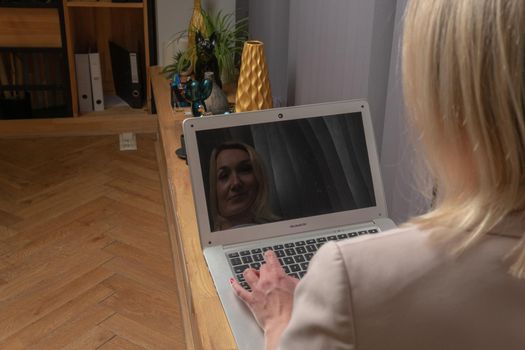 Girl typing in a laptop in a white business lady suit, a concept independent feminist woman laptop home student education, for online webinar from female from people sitting, internet desk. Eenage digital working, connection