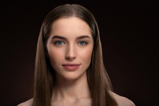 Natural beauty woman with no make up face portrait. Healthy pure skin model posing on camera isolated on black background. Natural make up concept. Spa and beautiful concept.